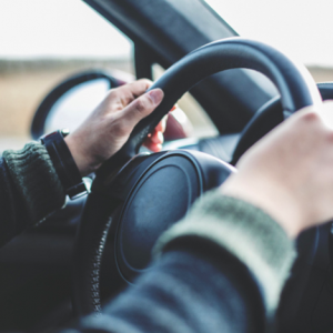 Hands on a car steering wheel